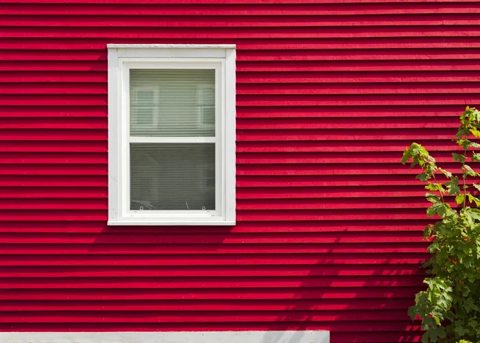 Red vinyl siding on a house exterior wall