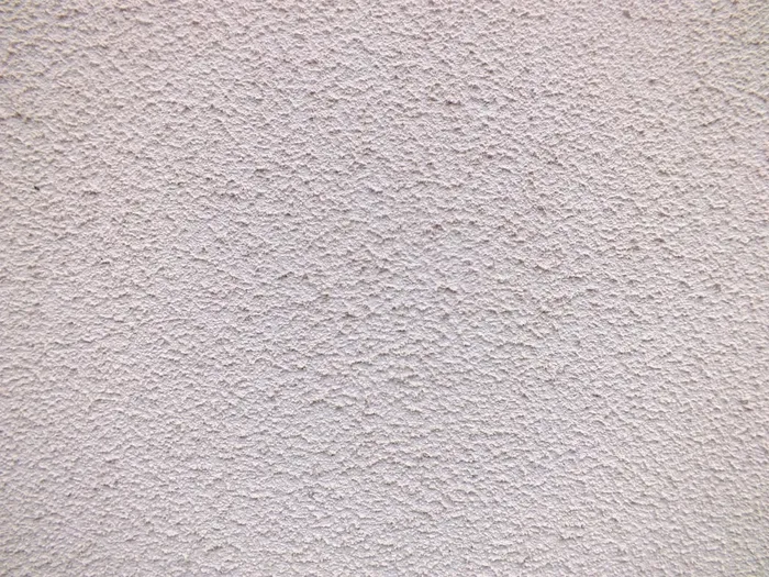 Close-up of a textured white stucco exterior wall