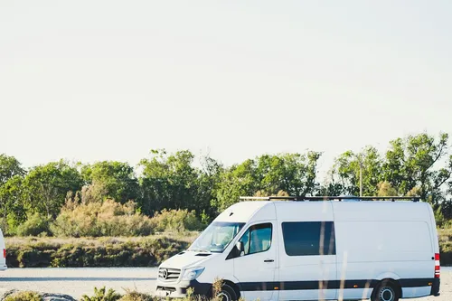 A white service van parked on a road near Gilbert, Arizona
